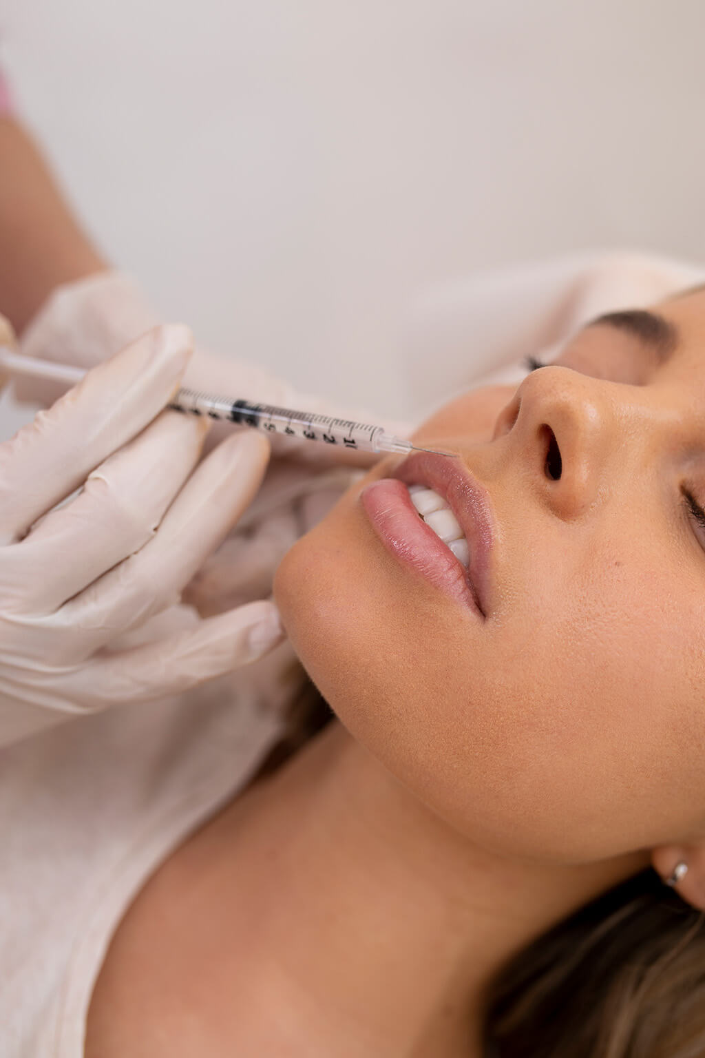 Woman getting lip filler injection at Omnia Integrative Health & MedSpa in West Lawn, PA