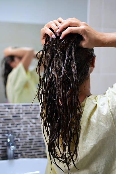 Reflection of woman with dyed hair in mirror