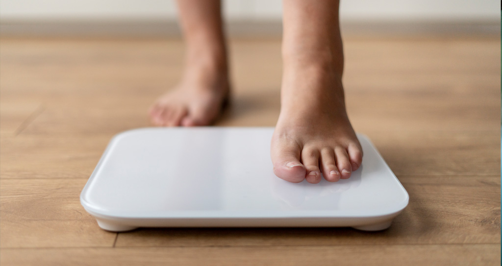 weight-loss Person stepping on scale